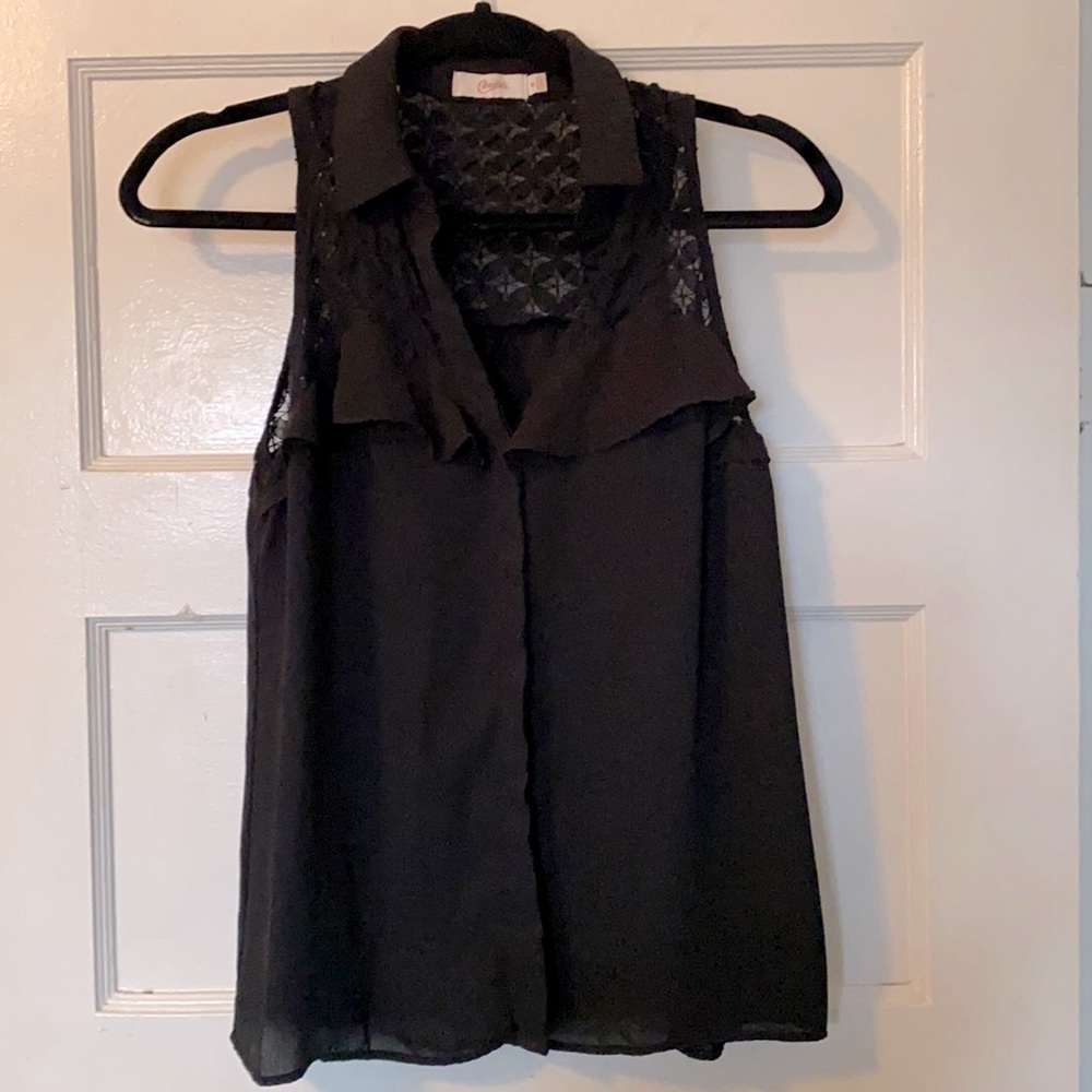 Black sleeveless button down top.